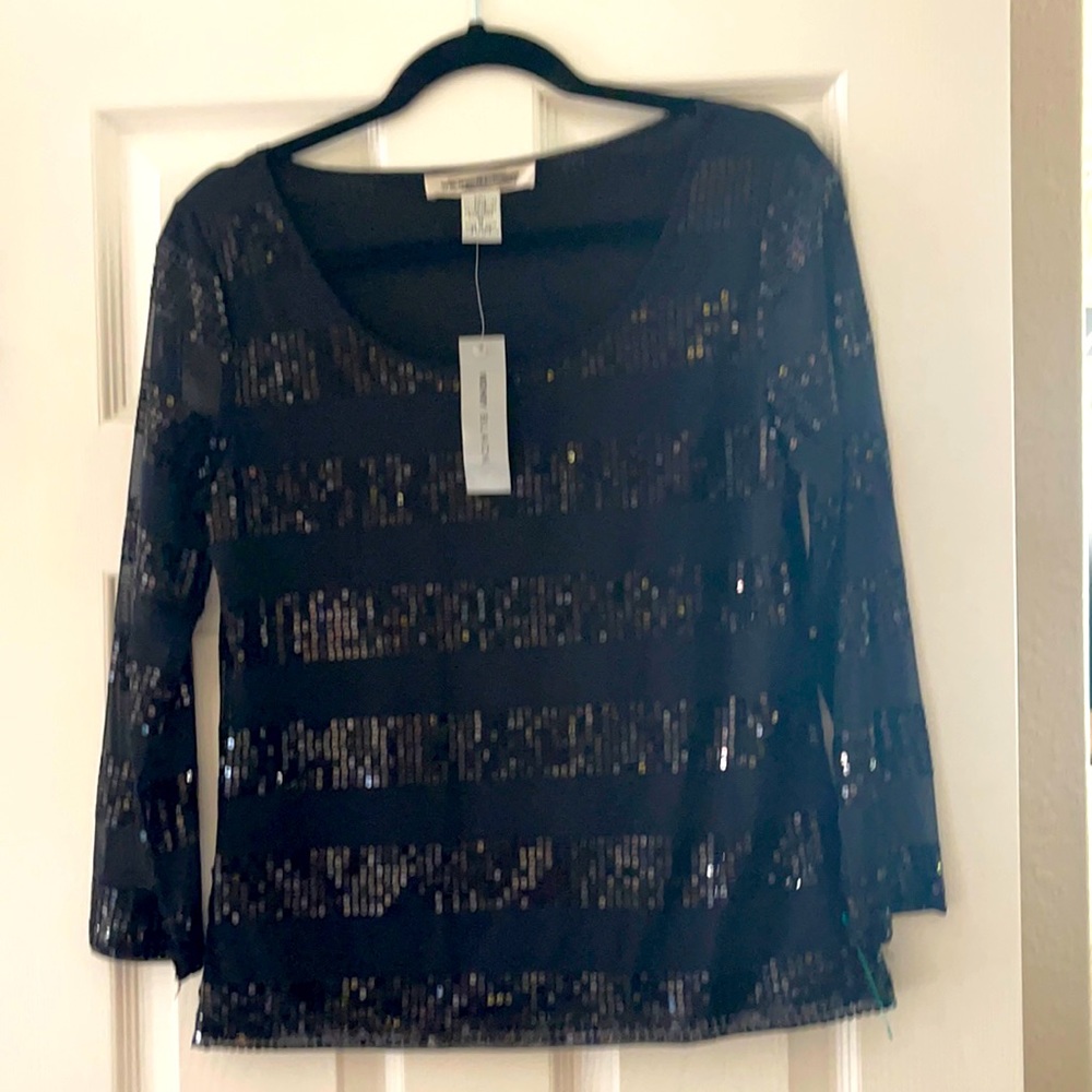 A woman’s black sequin top size medium still has the tags